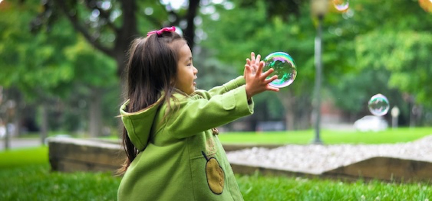 Children playing with bubbles outdoors